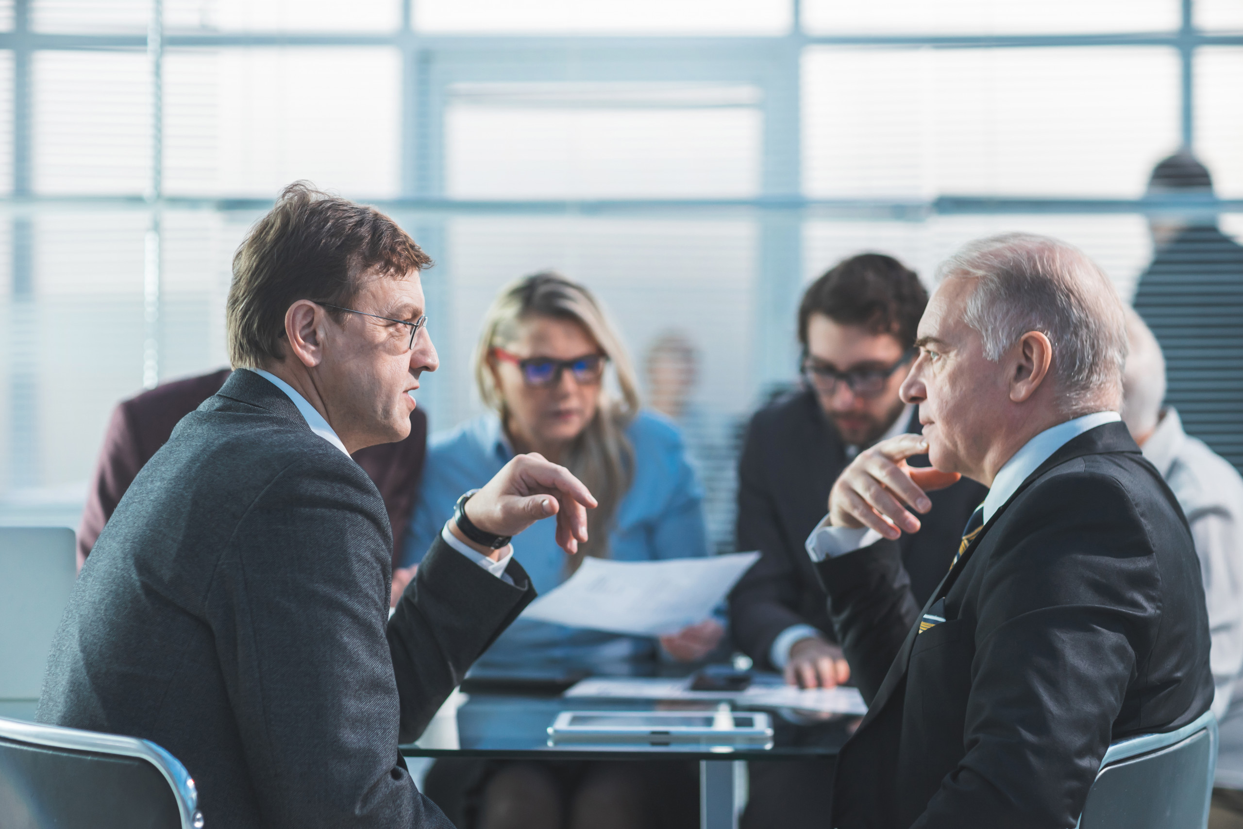 serious business people discuss problems at a work meeting
